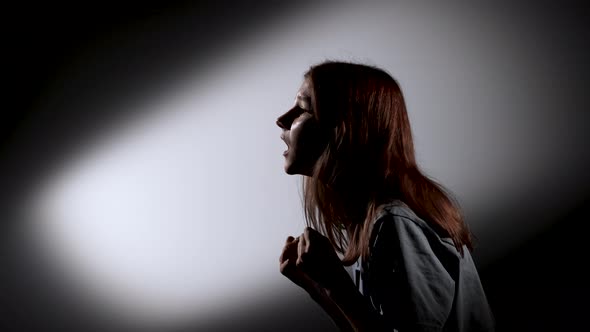 Side View Silhouette of an Excited Young Girl Screaming in Fear