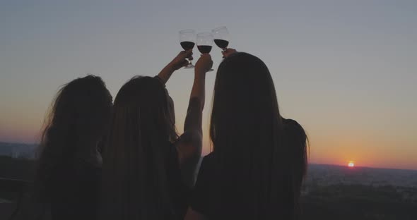 Three Ladies at Sunset on the Loft Balcony Admire