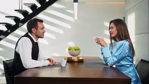 Employees of a Modern Office Sitting Drinking Coffee at the Table