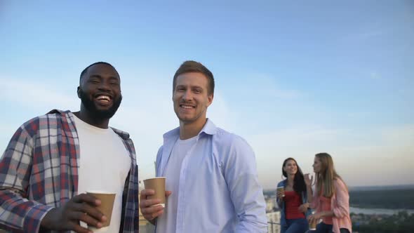 Multiracial Male Friends With Cocktails Smiling at Camera, Roof Party, Relax