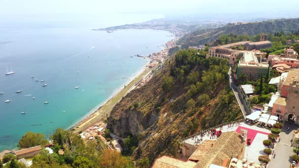 Flying across the edge of the ancient town on the hill. Moving along the mountain towards the beauti