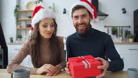 Portrait of Affectionate Sincere Loving Couple Getting Gift Looking at Camera