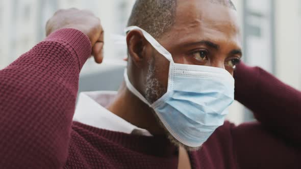 African american man on the go wearing coronavirus covid19 mask