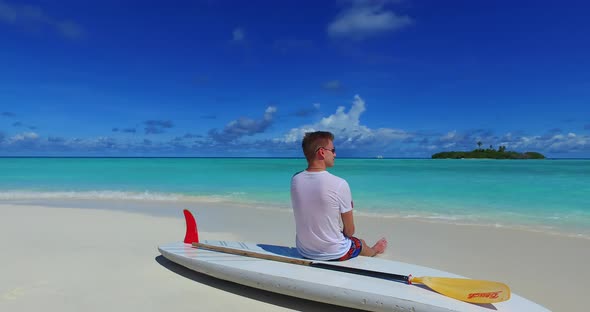 Happy man and woman on honeymoon vacation have fun on beach on clean white sand background