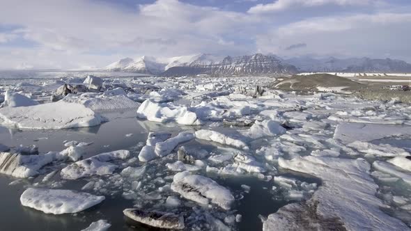 Aerial view of Jokulsarlon glacier lagoon with iceberg floating and mountains