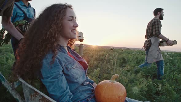 Laughing Woman Riding Cart through Field