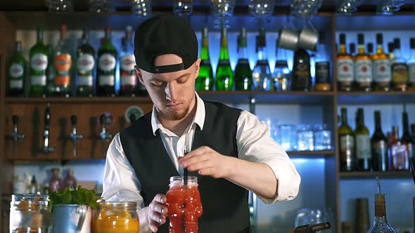 The Bartender Is Preparing an Alcoholic Cocktail.