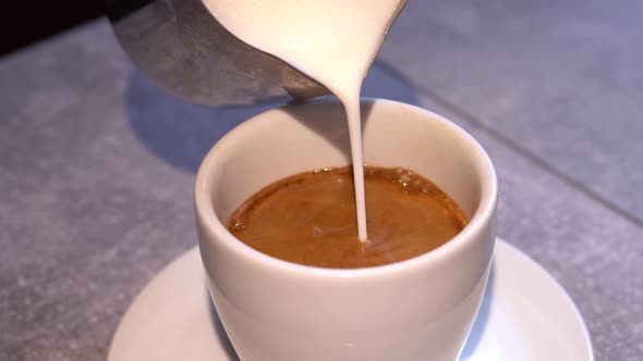 Preparation Process of Coffee with Shaked Up Milk  Latte or Cappuchino in White Cup