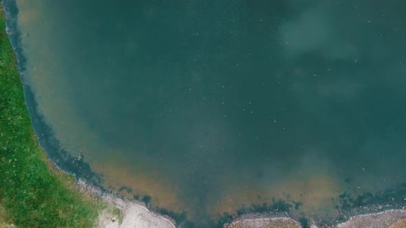 Top-Down View Of Serene Water On Pond In South Moravian Region, Czech Republic. - aerial ascend