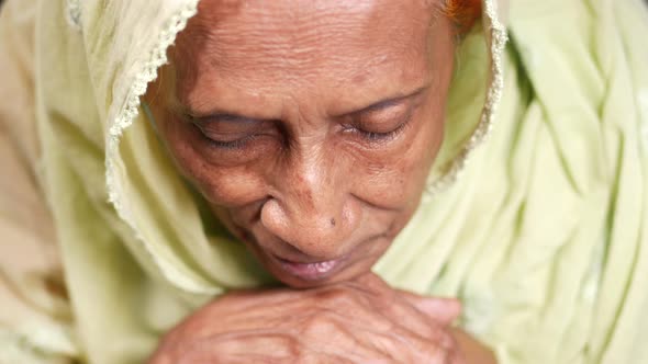 a Sad Senior Asian Women Looking Down