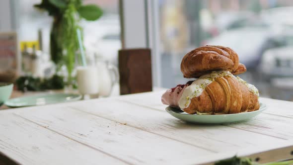 Three Croissants on a White Wooden Background