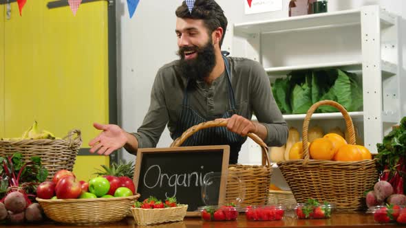 Smiling staff standing in organic section