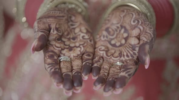 Closeup of Henna Applied Hands of Indian Bride Getting Ready for Her Traditional Indian Wedding