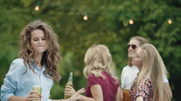 Beautiful Girl Dancing With Friends At Outdoor Party.