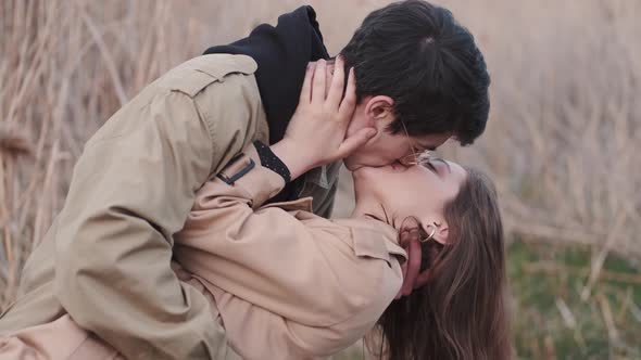 Boy in Glasses and Girl Kissing and Having Date in Reeds