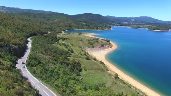 Aerial view of paved road passing artificial lake of Peruca, Croatia