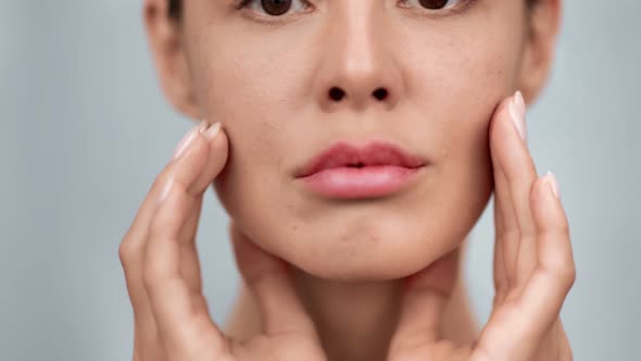 Closeup Female Model with Perfect Skin Applying Moisturizing Cream Isolated