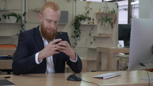 Businessman Using Smart Phone Indoors