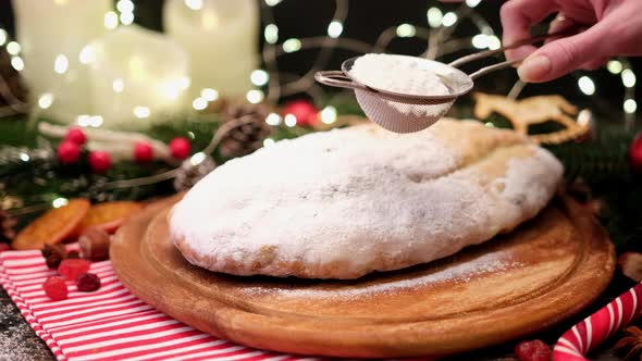 Traditional Christmass Stollen Cake with Marzipan and Dried Fruit on Rustic Background