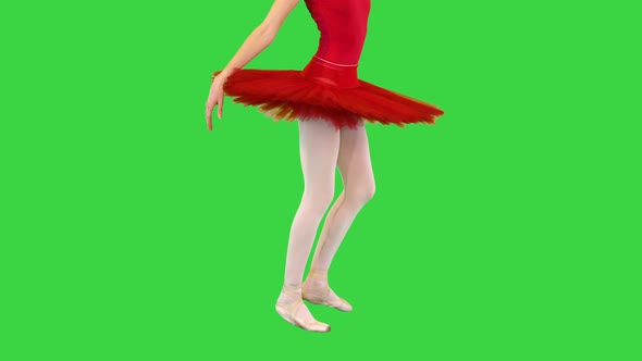 Young Ballerina in Red Classical Tutu Walks Demipointe and Makes Arms Movements on a Green Screen