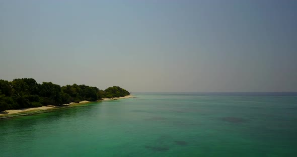 Beautiful Aerial Tourism Shot of A Paradise Sunny White Sand Beach and Blue Sea Background