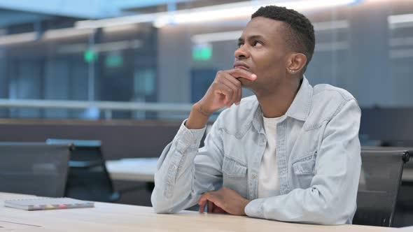 Thinking African Man Sitting in Office