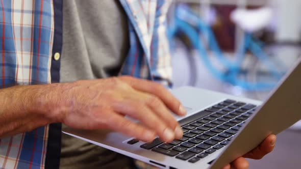 Male business executive using laptop