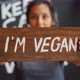 Young Mixed Race Woman Holding Wooden I Am Vegan Sign. Healthy Lifestyle Propaganda Concept - VideoHive Item for Sale