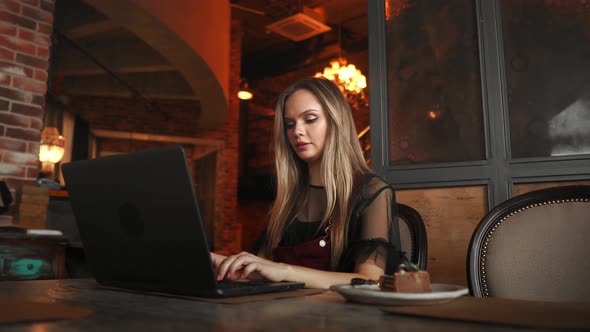 Beautiful Hipster Woman Using Laptop at Cafe