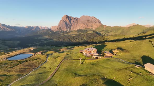 Dolomites cottages under the rugged peaks at sunrise