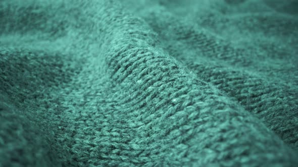 Extreme detail view of sheep wool cloth texture flowing in macro dolly shot.