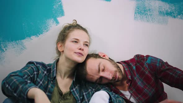 Tired Caucasian Couple After They Painting a Wall