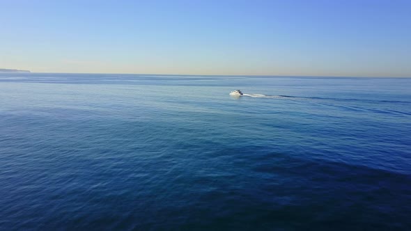 Aerial drone uav view of a motor boat and the ocean.