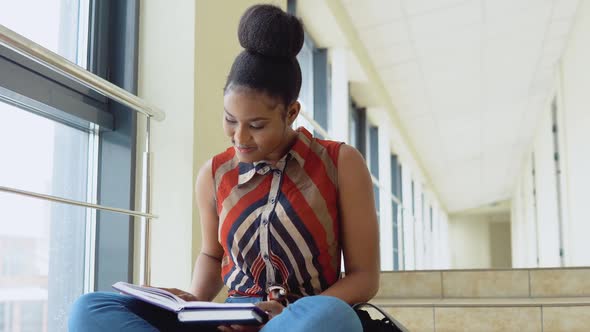 African American Woman Student with a Books in the University