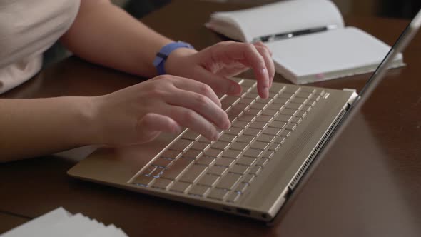 Female Hands are Typing Text on Laptop Keyboard