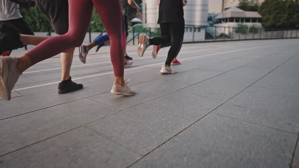 Multiracial Team of Likeminded People Running Through the City Streets