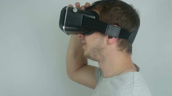 Man Is Testing A Modern Helmet Of Virtual Reality