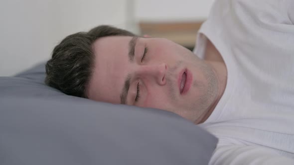 Man Coughing While Sleeping in Bed Close Up