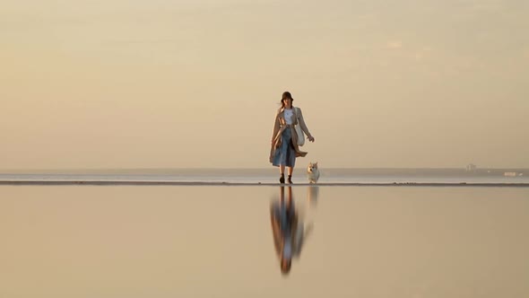 Woman Walk on the Beach and Dog Chasing Owner