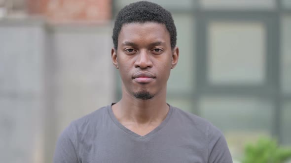 Portrait of Young African Man Looking at Camera