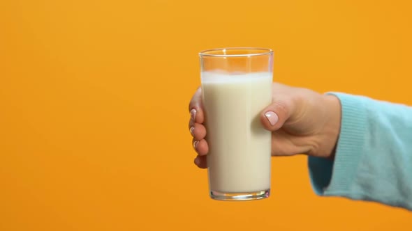 Lady Refusing Glass of Milk Offered by Person, Allergy and Lactose Intolerance
