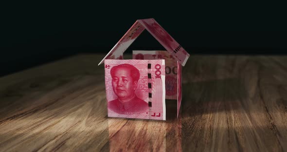 China Yuan 100 CNY money banknotes paper house on the table