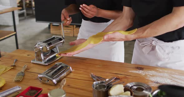 Diverse group of chefs preparing dishes and smiling in a kitchen