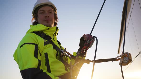 Industrial Climber Hangs on Safety Ropes on Skyscraper