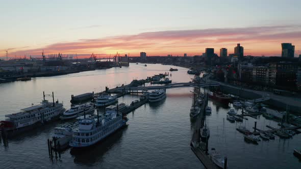 Aerial Descending View of Ferries and Boats Anchored in Hamburg Port on River Elbe During Sunset
