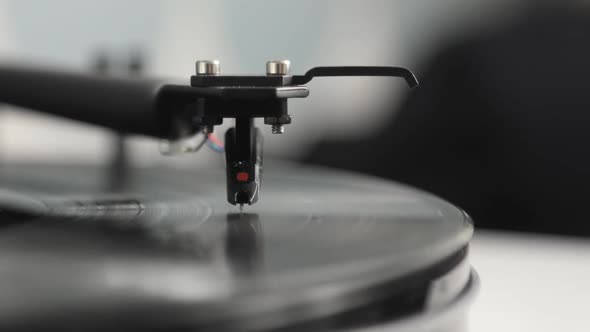 Needle and Arm on Spinning Vinyl Record Turntable Player