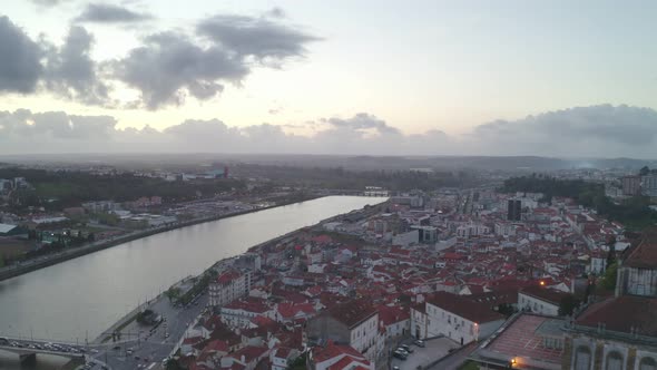 Aerial drone view of Coimbra city and Mondego river at sunset