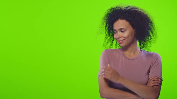 African American Woman in Pink T-shirt Points To Something