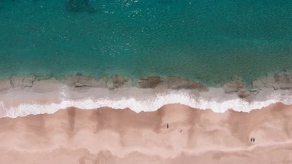 Ocean blue waves break on sandy beach