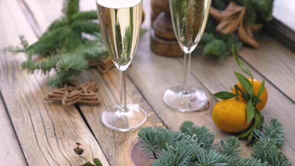 Christmas Table at the Winter Window. Two Glasses of Champagne, Candles in Wooden Candlesticks and